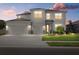 Two-story house with three-car garage and landscaping at 17015 Harvest Moon Way, Bradenton, FL 34211