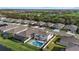 Aerial view of a house with pool, near golf course and lake at 17015 Harvest Moon Way, Bradenton, FL 34211