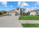 Modern two-story house with a three-car garage and manicured lawn at 17015 Harvest Moon Way, Bradenton, FL 34211