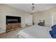 Main bedroom with king-size bed and large TV at 17015 Harvest Moon Way, Bradenton, FL 34211