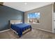 Bedroom with dark blue accent wall and window view at 17015 Harvest Moon Way, Bradenton, FL 34211