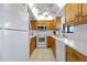 Condo kitchen with white appliances and wood cabinets at 208 Lewis Cir # 4A, Punta Gorda, FL 33950