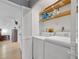 Functional laundry room with washer, dryer, and shelving at 208 Lewis Cir # 4A, Punta Gorda, FL 33950
