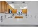 Condo kitchen with white appliances and wood cabinets at 208 Lewis Cir # 4A, Punta Gorda, FL 33950