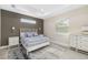 Serene bedroom with tray ceiling, stylish decor, neutral walls, and an abundance of natural light at 2129 Lorraine Dr, Port Charlotte, FL 33953