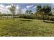 Fenced backyard with grassy area and pond view at 225 Daylily Blvd, Nokomis, FL 34275
