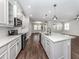 Open concept kitchen features stainless steel appliances and an island at 225 Daylily Blvd, Nokomis, FL 34275