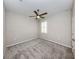 Bright bedroom with grey carpet and ceiling fan at 225 Daylily Blvd, Nokomis, FL 34275