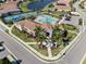 Community clubhouse with pool and palm trees in an aerial view at 225 Daylily Blvd, Nokomis, FL 34275