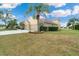 Tan house exterior with three-car garage and manicured lawn at 246 Petrel Trl, Bradenton, FL 34212