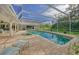 Inviting pool area with covered patio and lush landscaping at 3017 Wilderness E Blvd, Parrish, FL 34219