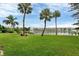 Landscaped area with lake view and bench at 3532 Lake Bayshore Dr # K117, Bradenton, FL 34205