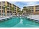 Community pool with surrounding lounge chairs at 3532 Lake Bayshore Dr # K117, Bradenton, FL 34205