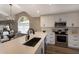 Modern kitchen with white cabinets, stainless steel appliances, and island at 4904 Linsey Ct, Sarasota, FL 34243