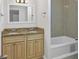 Bathroom with double vanity, granite countertop, and tub at 5010 8Th N Ave, St Petersburg, FL 33710