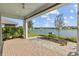 Covered patio overlooking a tranquil lake at 5831 Mezzana Run, Palmetto, FL 34221