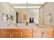 Double vanity bathroom with marble countertop and large mirror at 6223 90Th Avenue E Cir, Parrish, FL 34219