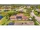 Aerial view of home with pool and solar panels, situated in a quiet residential neighborhood at 6223 90Th Avenue E Cir, Parrish, FL 34219
