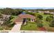 Aerial view of single-Gathering home with a large yard and water view at 6223 90Th Avenue E Cir, Parrish, FL 34219