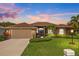Beautiful home exterior at dusk with landscaping at 6223 90Th Avenue E Cir, Parrish, FL 34219