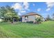 Backyard view showcasing the home's side elevation and landscaping at 6223 90Th Avenue E Cir, Parrish, FL 34219