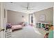 Bright bedroom with a pink bed, built-in shelves, and ample natural light at 6223 90Th Avenue E Cir, Parrish, FL 34219