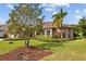 Well-maintained front yard with lush landscaping and a charming home exterior at 6223 90Th Avenue E Cir, Parrish, FL 34219