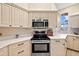 Modern kitchen with white cabinets, quartz countertops and stainless steel appliances at 6223 90Th Avenue E Cir, Parrish, FL 34219