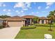Single-story home with attached garage and well-maintained landscaping at 6223 90Th Avenue E Cir, Parrish, FL 34219