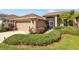 Single-story home with attached garage and lush landscaping at 6223 90Th Avenue E Cir, Parrish, FL 34219