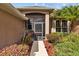 Front entry with a screened porch and manicured landscaping at 6223 90Th Avenue E Cir, Parrish, FL 34219