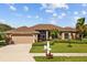 Single-story home with attached garage and well-maintained landscaping at 6223 90Th Avenue E Cir, Parrish, FL 34219