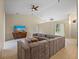 Bright living room featuring a large sectional sofa and flat-screen TV at 6223 90Th Avenue E Cir, Parrish, FL 34219