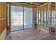 Unfinished bathroom featuring a large glass sliding door and exposed plumbing at 6489 Gulfside Rd, Longboat Key, FL 34228