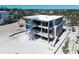 Aerial view of an under-construction home with scaffolding, showing progress and potential views at 6489 Gulfside Rd, Longboat Key, FL 34228