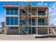 Under-construction home featuring large windows, a temporary staircase, and unfinished exterior at 6489 Gulfside Rd, Longboat Key, FL 34228