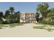 Stunning beachside home with multiple balconies, lush tropical landscaping, and a private beach at 6489 Gulfside Rd, Longboat Key, FL 34228