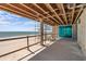 Under-construction covered patio with exposed ceiling beams offering ocean views, and direct beach access at 6489 Gulfside Rd, Longboat Key, FL 34228