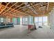 Exposed framing reveals layout for future living space with beach views from large sliding glass doors at 6489 Gulfside Rd, Longboat Key, FL 34228