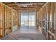 Unfinished interior with exposed beams and large sliding glass doors at 6489 Gulfside Rd, Longboat Key, FL 34228