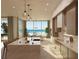Bright kitchen with marble island and hardwood floors, offering ocean views through large windows at 6489 Gulfside Rd, Longboat Key, FL 34228
