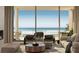 Stylish living room area providing stunning views through large windows and comfortable seating at 6489 Gulfside Rd, Longboat Key, FL 34228