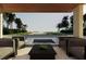 Inviting outdoor patio area with comfortable seating, a water feature, and scenic views of lush tropical landscape at 6489 Gulfside Rd, Longboat Key, FL 34228