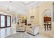 Living room with two armchairs and view into dining area and kitchen at 7659 Trillium Blvd, Sarasota, FL 34241