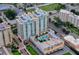 Stunning aerial view of Alinari high-rise condos featuring a pool deck and lush landscaping at 800 N Tamiami Trl # 307, Sarasota, FL 34236