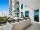 Spacious outdoor balcony with seating area and view of the building's exterior at 800 N Tamiami Trl # 307, Sarasota, FL 34236