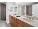 Elegant bathroom with double sinks, neutral tile, walk-in shower, and modern fixtures at 800 N Tamiami Trl # 307, Sarasota, FL 34236