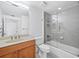 Modern bathroom featuring a shower-tub combination with glass doors and wood vanity at 800 N Tamiami Trl # 307, Sarasota, FL 34236