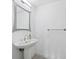 Small bathroom with pedestal sink, mirror, and modern fixtures at 800 N Tamiami Trl # 307, Sarasota, FL 34236