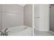 Well-lit bathroom featuring a soaking tub and tiled shower at 800 N Tamiami Trl # 307, Sarasota, FL 34236